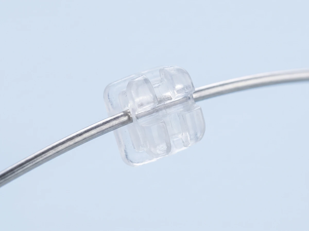 Concept illustration: a clear ceramic bracket on a steel archwire