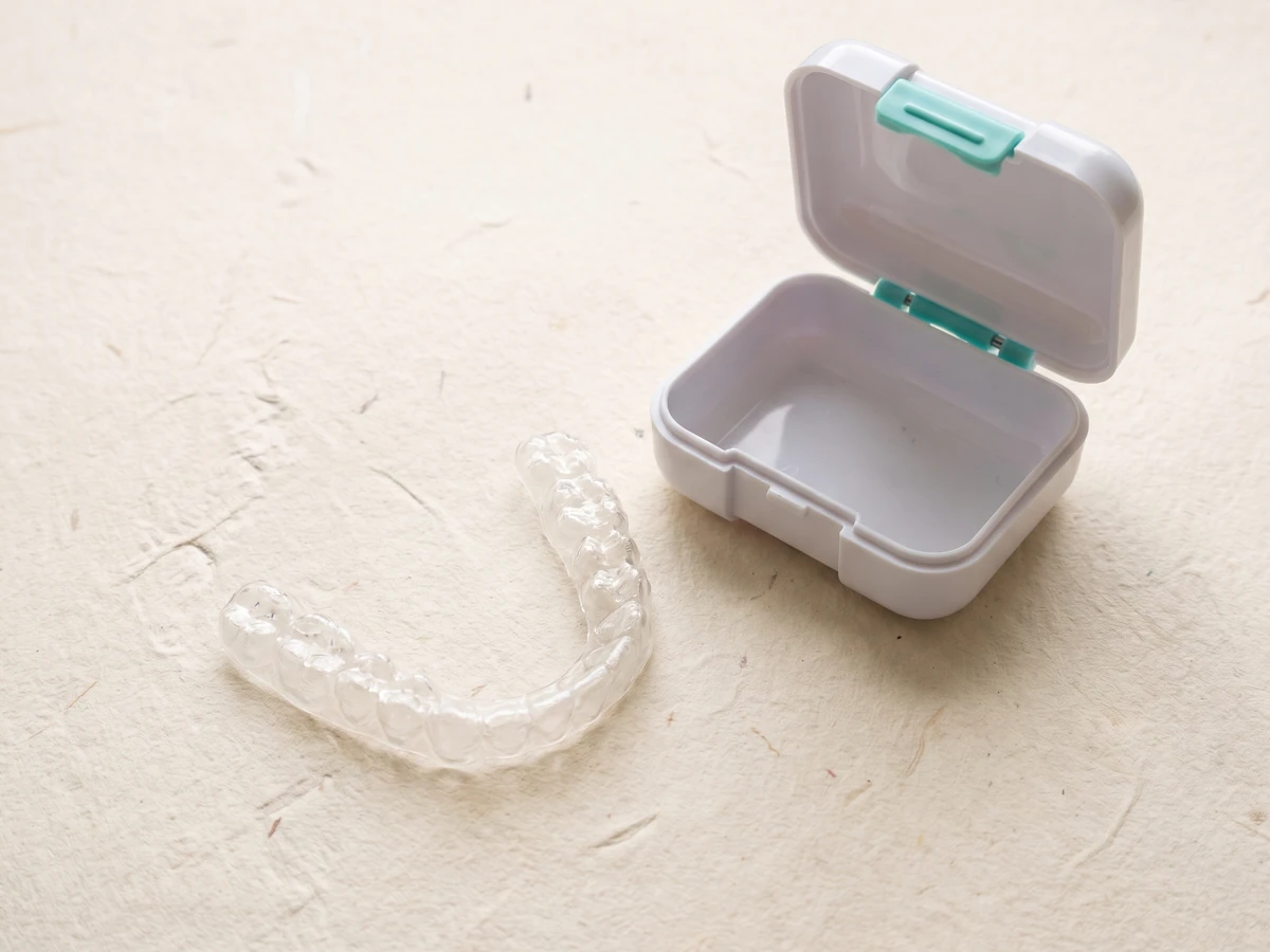 Concept illustration: a clear retainer beside its case